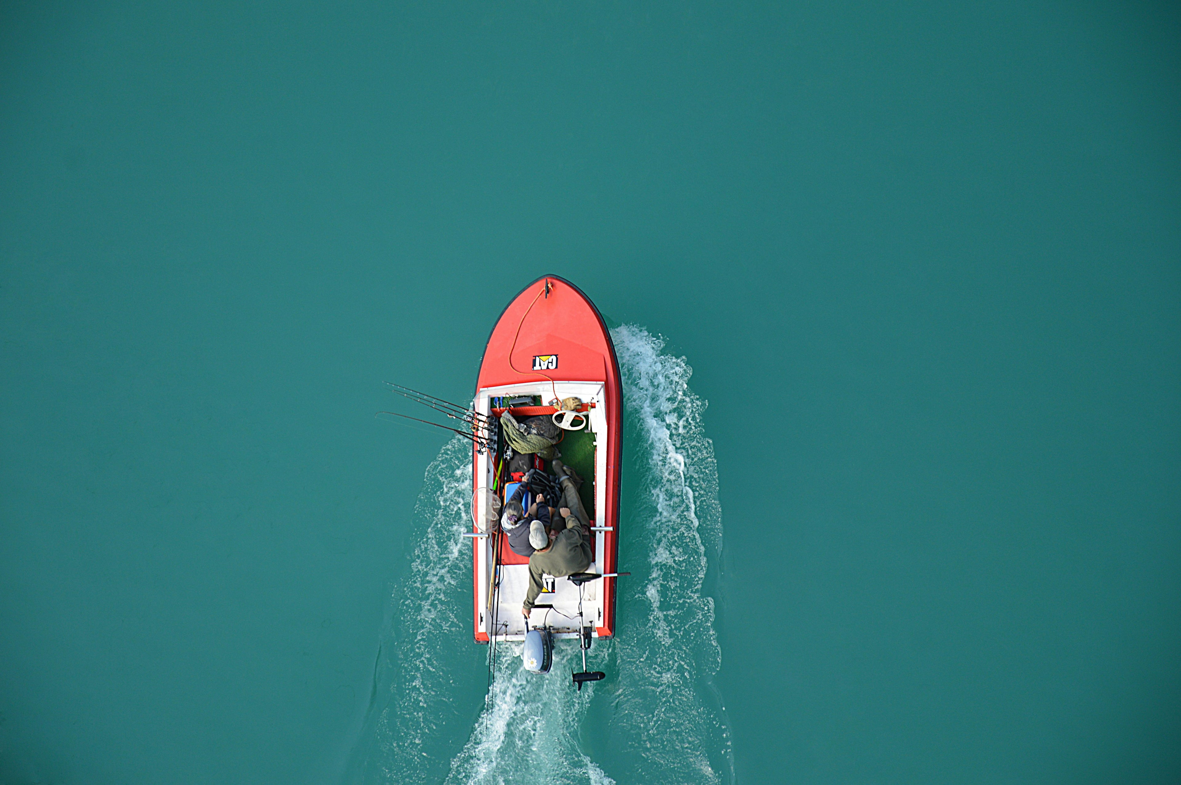 aerial view of an orange fishing boat on the water