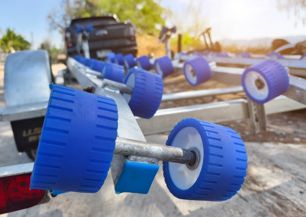 closeup of roller wheels on a diy boat ramp on a trailer
