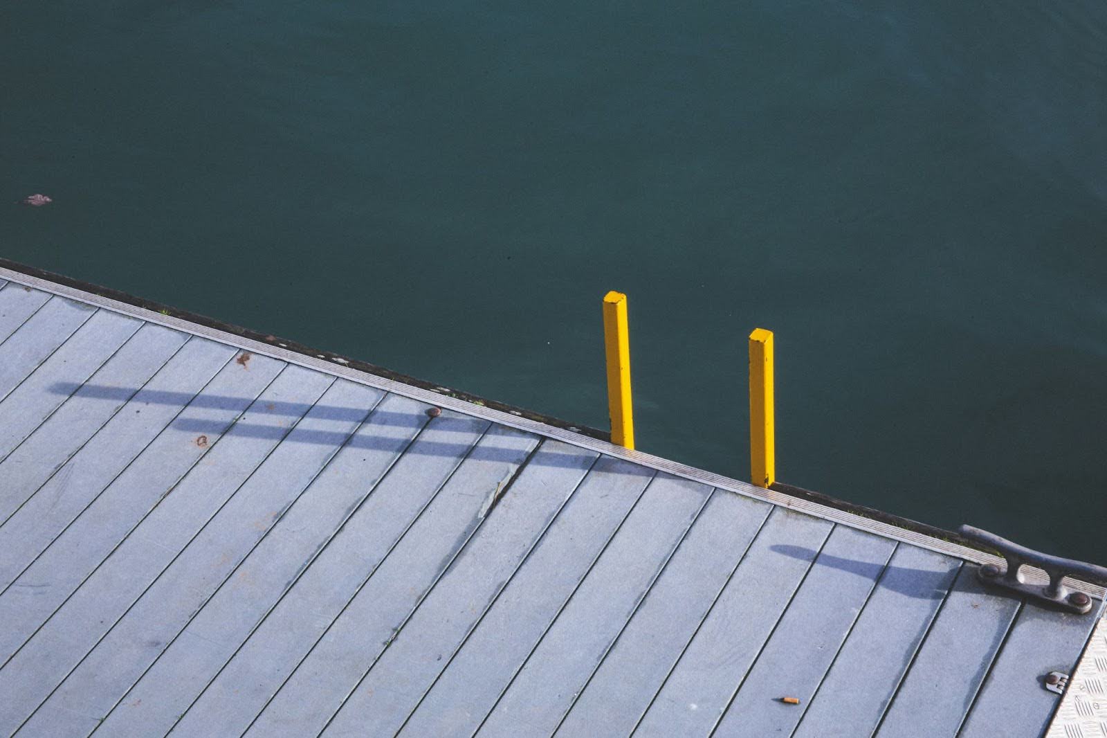 edge of a dock with a yellow ladder sticking up