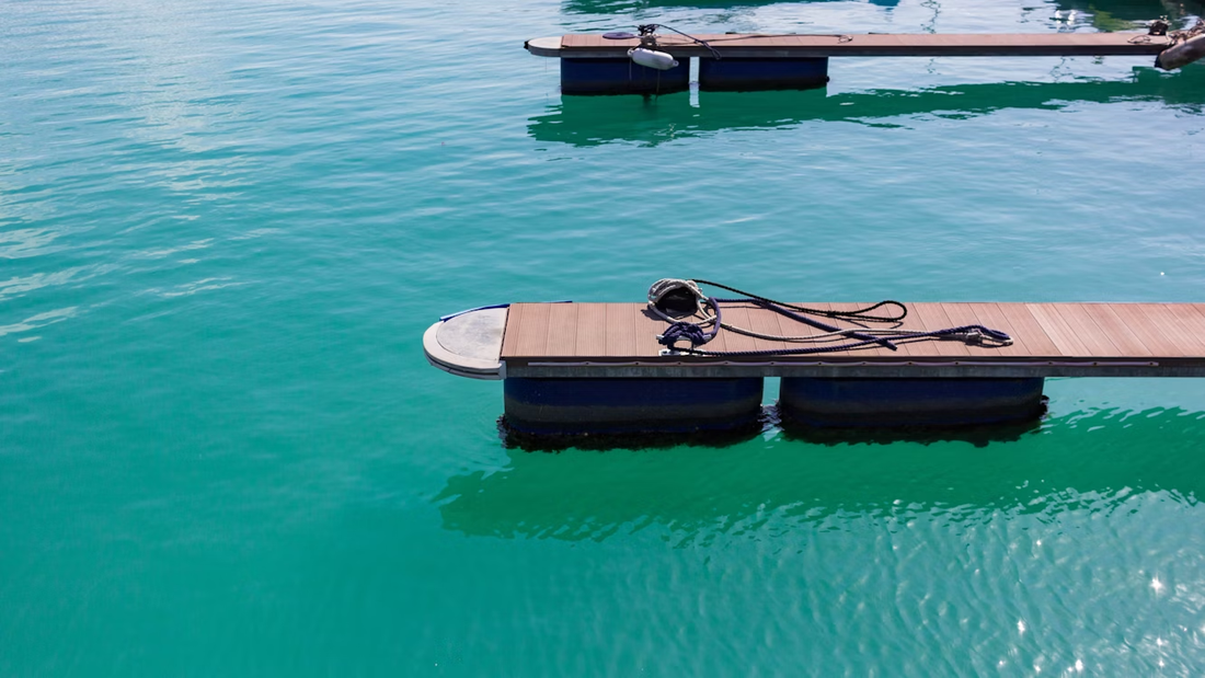 two floating docks on a clear lake shoreline