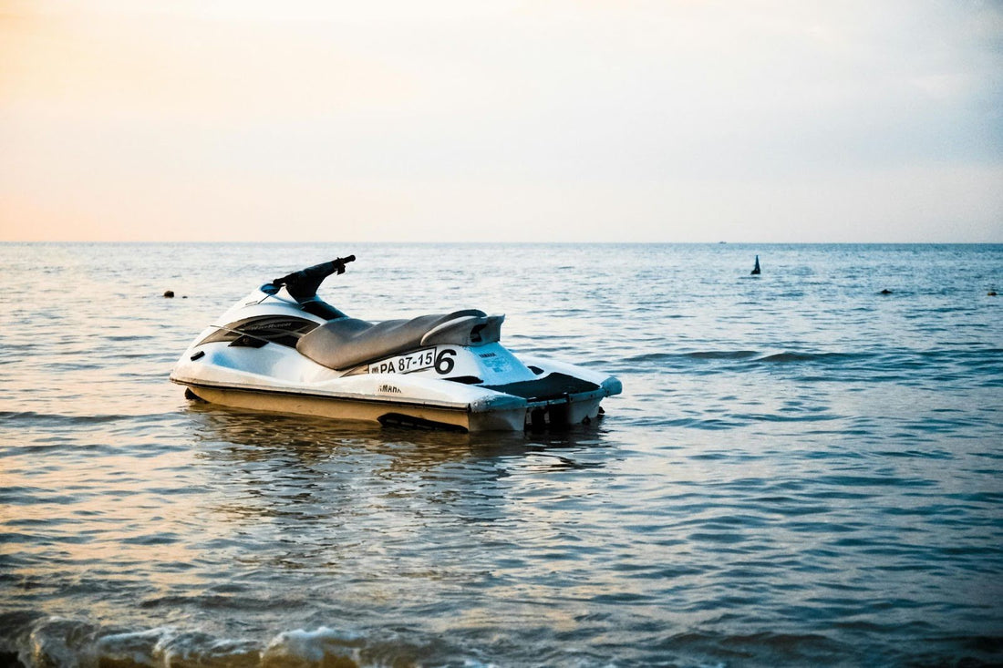 jet ski on a shimmering body of water during sunrise