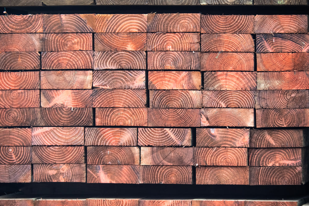 wood end grains of stacked, pressure treated lumber