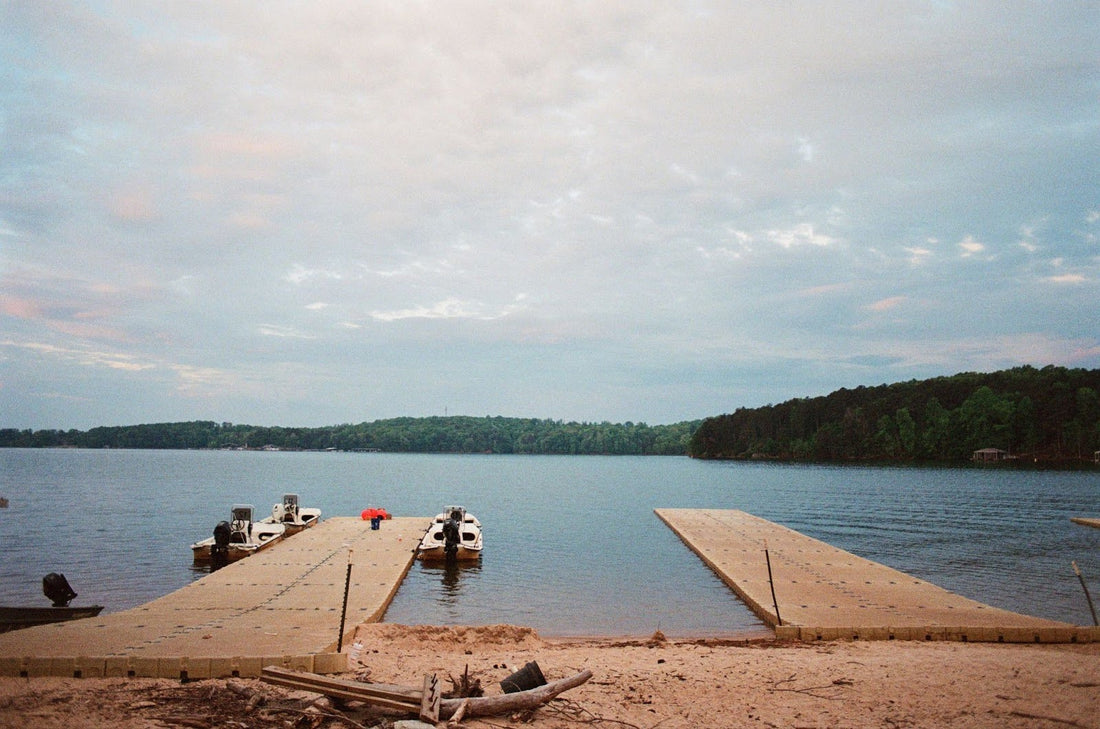 boats on a floating dock off of a beach shoreline